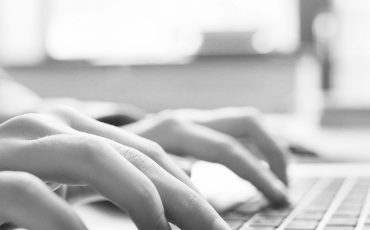 Website technical content writer. Network service. Social media blogging. Closeup of hands typing on laptop, creating new article.